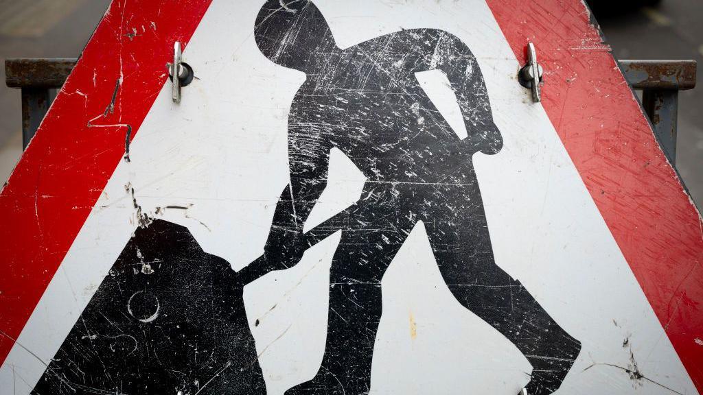 A close-up of a roadworks sign.