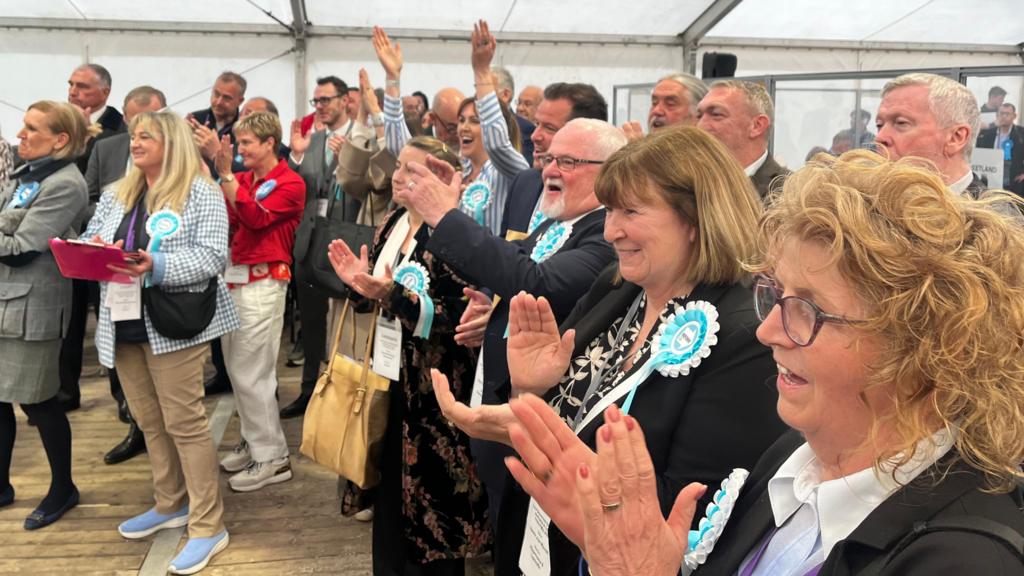 A crowd of cheering Reform UK supporters