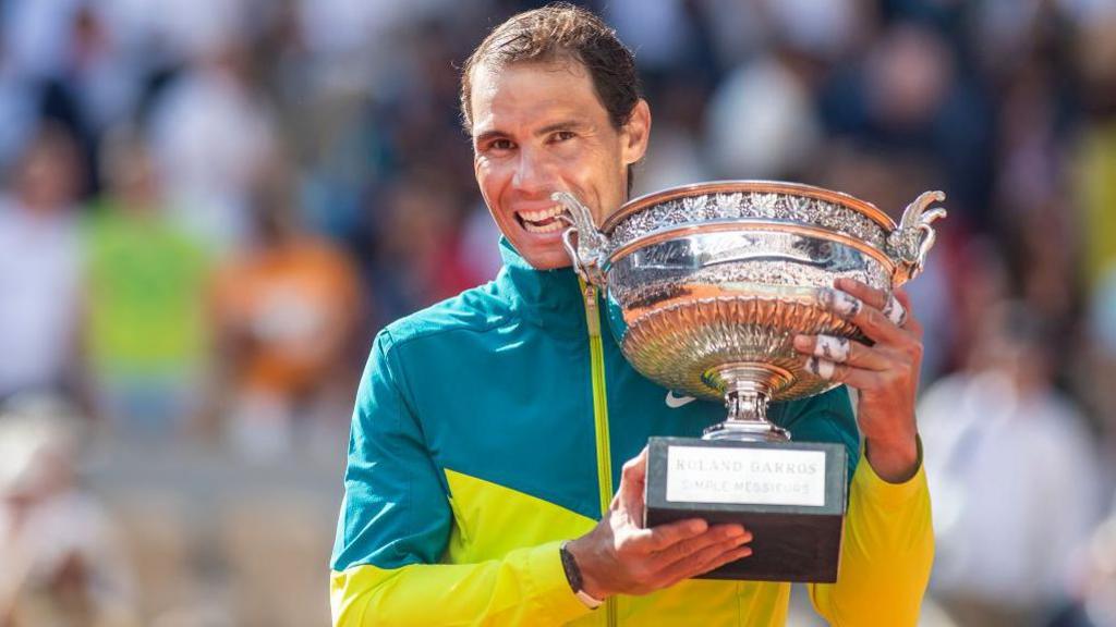 Rafael Nadal celebrates with the trophy following his 2022 victory