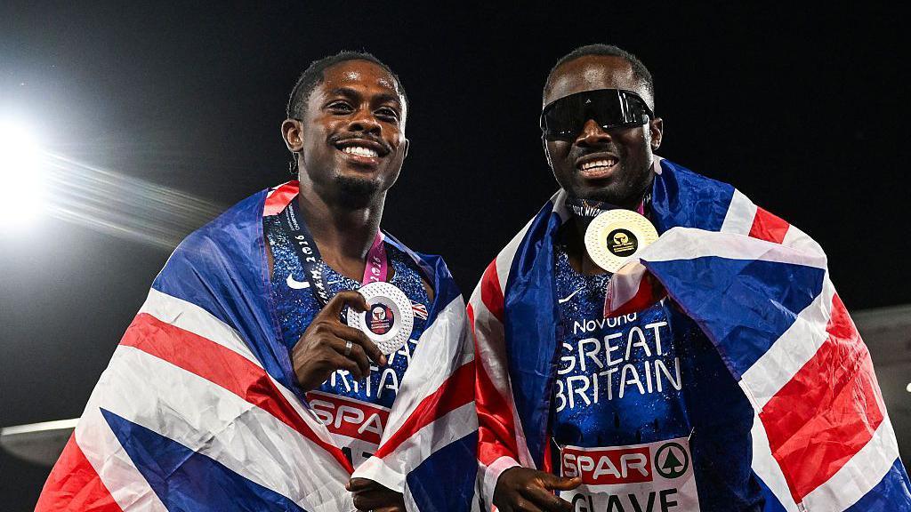 Silver medallist Jeremiah Azu (on the left) and gold medallist Romell Glave (on the right) celebrate after competing in the men's 100m final.