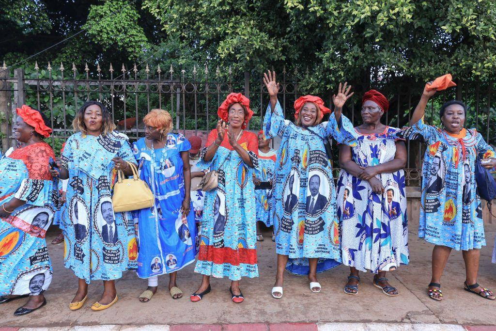 Supporters of the ruling CPDM party cheer as they wait for President Paul Biya to drive past them.