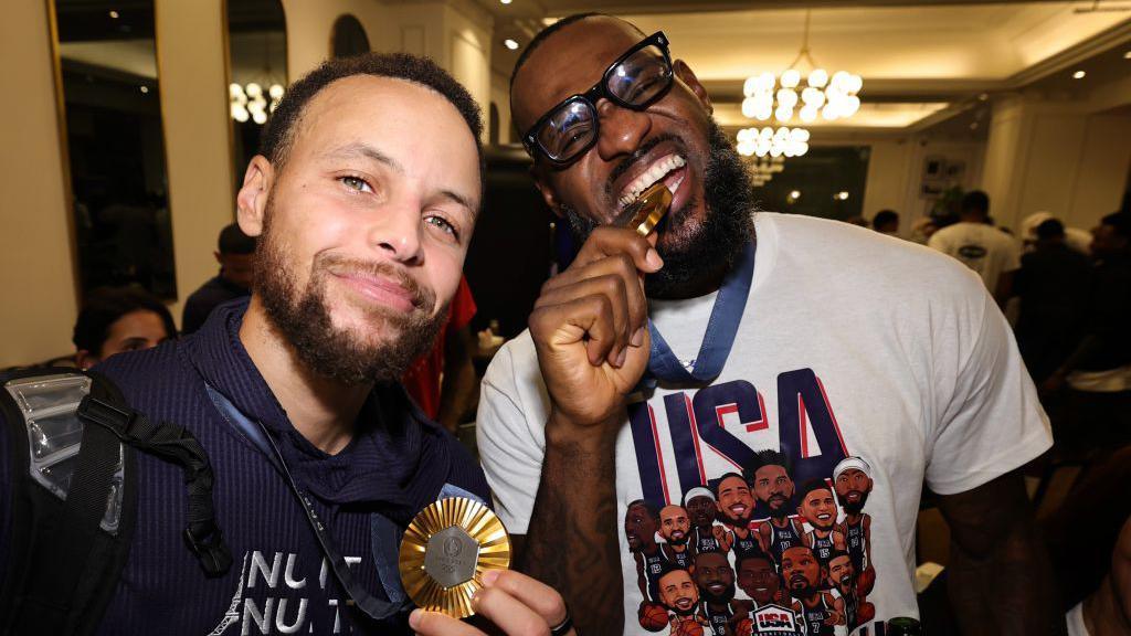 Steph Curry and LeBron James pose for a selfie with their Olympic gold medals