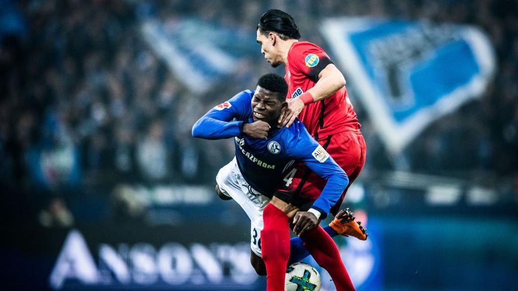 Breel Embolo is fouled while playing for Schalke against Hertha Berlin