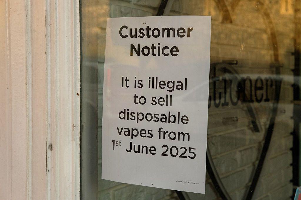 A paper sign in a shop window reading: 'Customer Notice: It is illegal to sell disposable vapes from 1st June 2025'