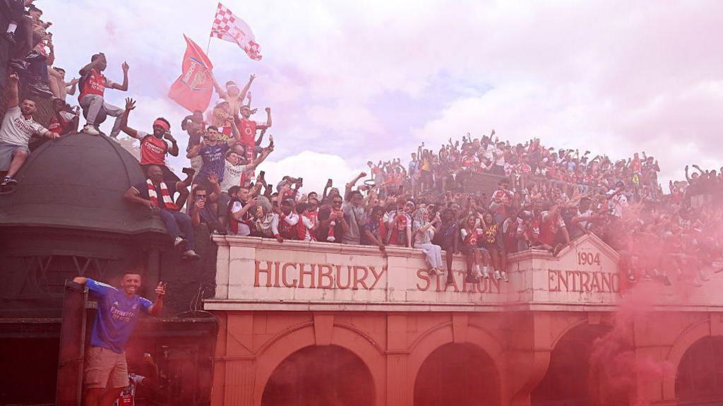 Arsenal fans viewed the parade from any position possible