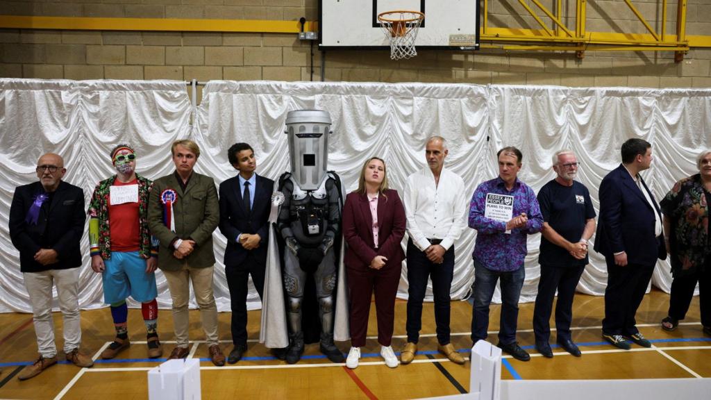 Count Binface stands with other candidates after Reform UK party leader Nigel Farage was declared the winner for the Clacton by-election.