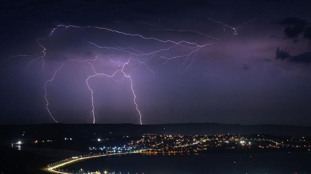 Lightning strikes over Weymouth against a night sky