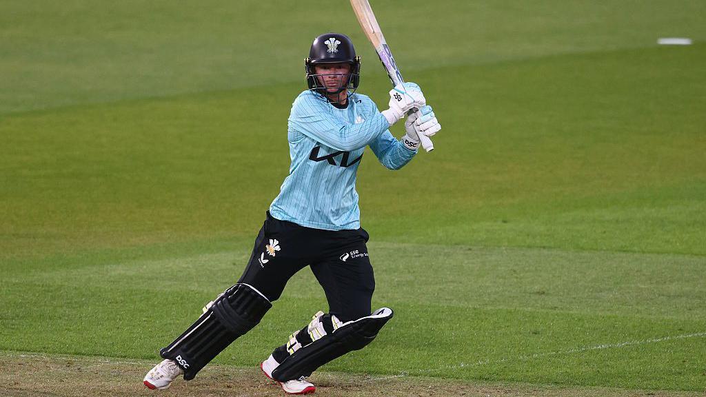 Danni Wyatt-Hodge runs after hitting the ball while batting for Surrey, dressed in the club's kit of dark blue pads, trousers and helmet and light blue top