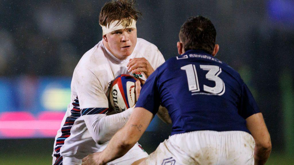 Henry Pollock runs at a French tackler