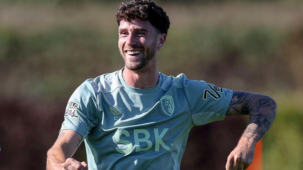 Bournemouth defender Marcos Senesi smiles during a training session