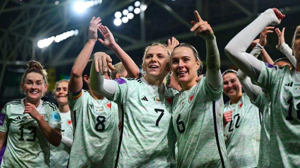 Wales players, including Ceri Holland, left, and Josephine Green celebrate after their side's victory in the Uefa Women's Euro 2025 play-off