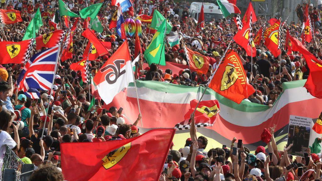 Fans hold Ferrari and Italian flags at Monza 