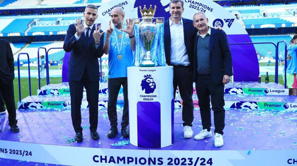 Manchester City chairman Khaldoon Al Mubarak, Manchester City manager Pep Guardiola, Manchester City Chief Executive Ferran Soriano and Manchester City Director of Football Txiki Begiristain pose with the Premier League trophy