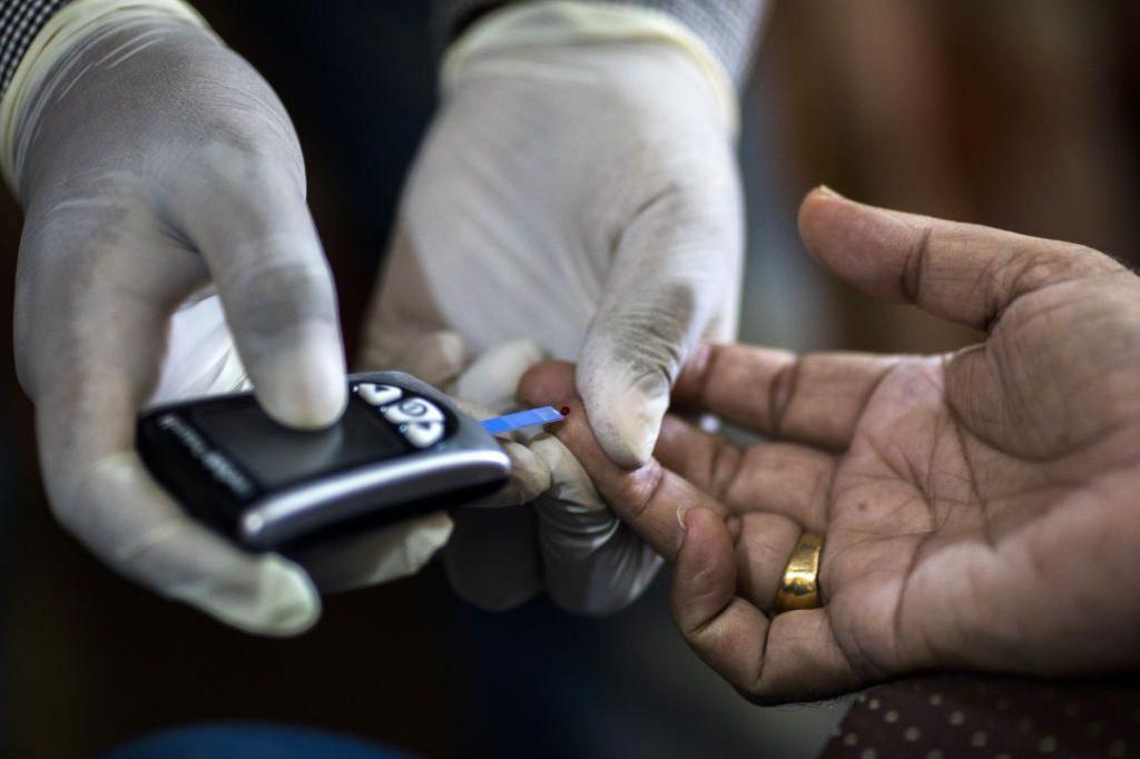 A Public Health Foundation of India worker conducts a blood glucose test for a patient during a free door-to-door screening program funded by Eli Lilly & Co. at a home in the farming village of Thana kalan, Haryana, India, on Thursday, July 13, 2017. Global pharmaceutical companies, from Indianapolis-based Eli Lilly to Switzerlands Novartis AG, are heading into smaller cities and rural areas to learn about the health-care needs of about 70 percent of the population. These remote regions of the developing world are the final frontier for the international drug industry. Photographer: Prashanth Vishwanathan/Bloomberg via Getty Images