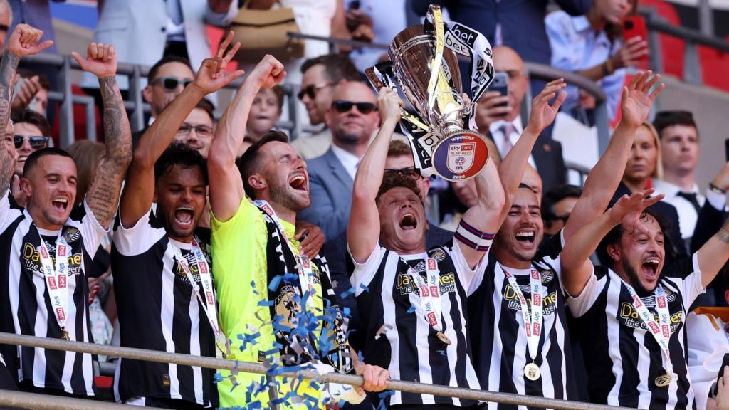 Notts County players lift the League Two play-off final trophy at Wembley
