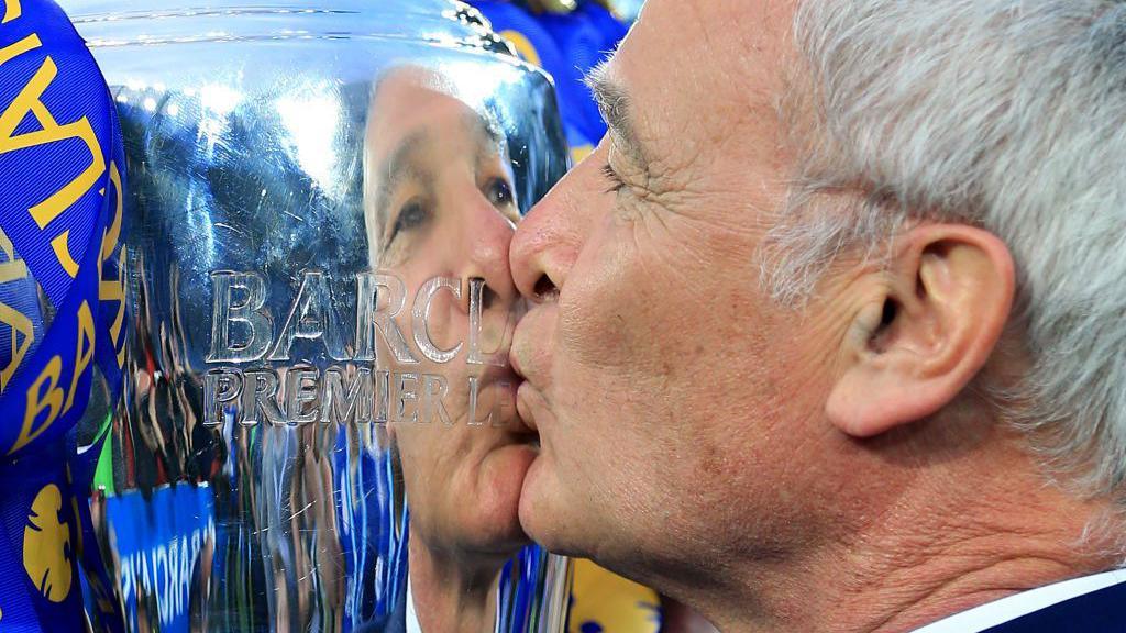 Claudio Ranieri kisses the Premier League trophy