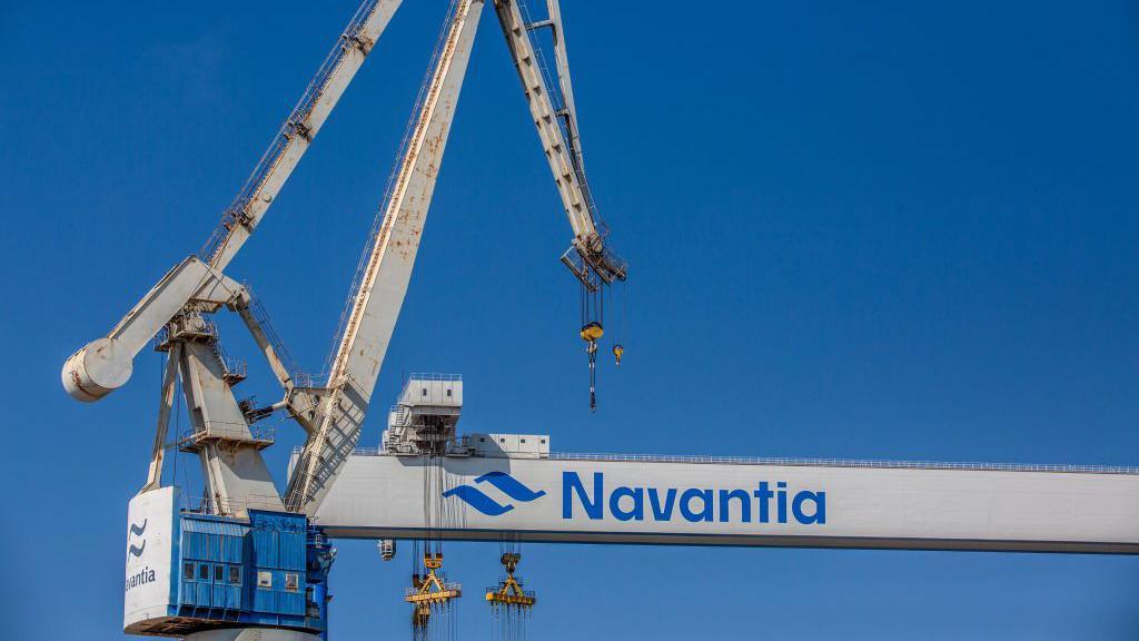 Gantry cranes at the Navantia SA shipyard in Cadiz, Spain, on Tuesday, Sept. 28, 2021. They are white cranes with the blue logo across the side of them