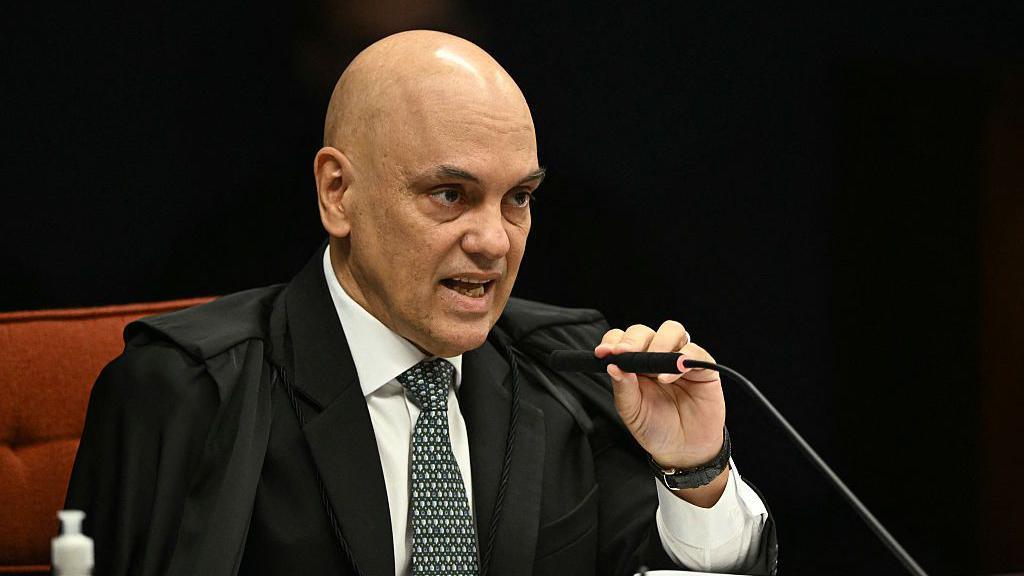 Alexandre de Moraes, wearing the black robe of a judge, speaks into a microphone during the final phase of Bolsonaro's trial on 2 September 2025