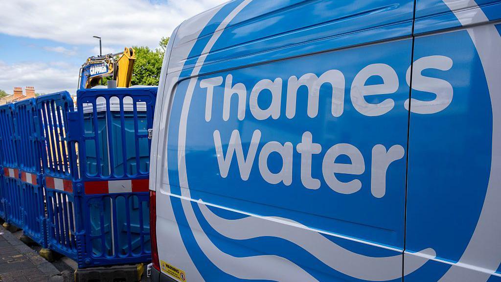 A Thames Water utility van parked on a London street next to construction work