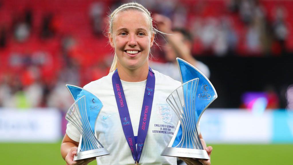 Beth Mead of England celebrates with the Player of the Tournament and Golden Boot trophies following the UEFA Women's Euro England 2022