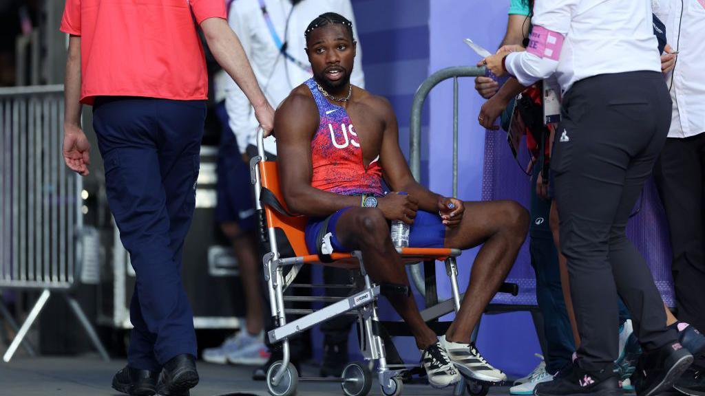 Noah Lyles in a wheelchair