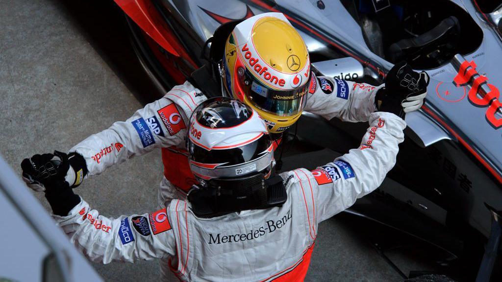 McLaren's Lewis Hamilton and Fernando Alonso celebrate in Malaysia.