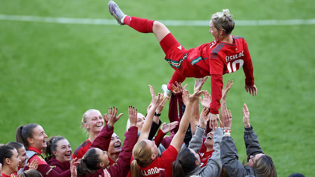 Jess Fishlock is thrown in the air by her team-mates after her final Wales game 
