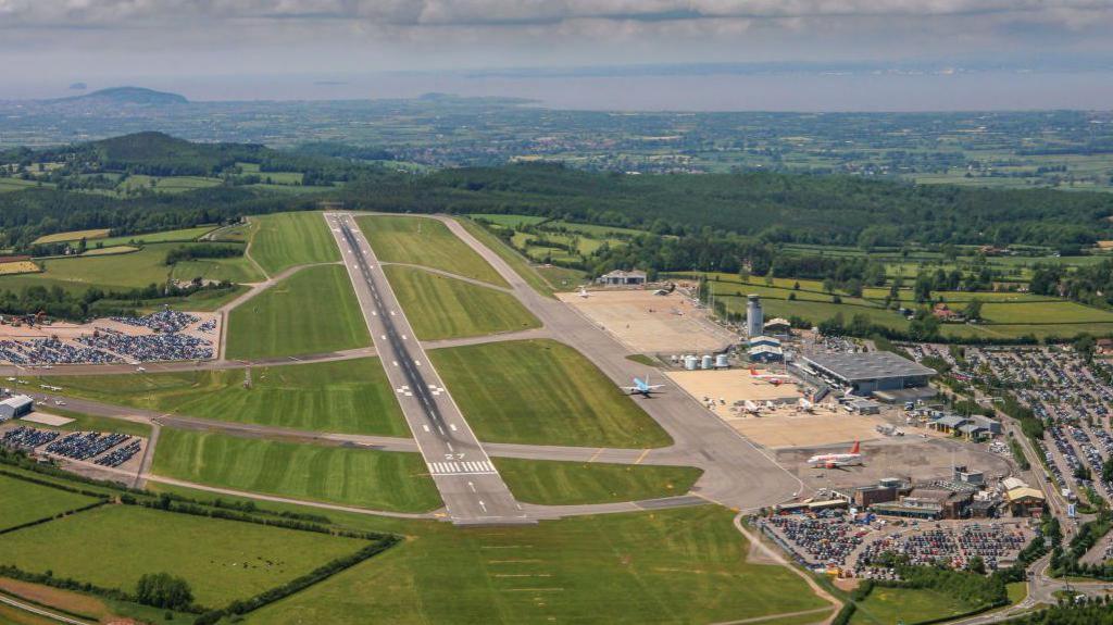 An aerial picture of Bristol Airport, showing a runway in the middle of the picture.