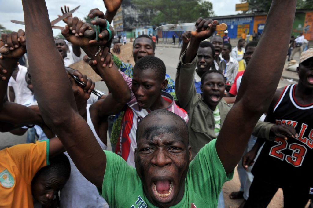 Young man are pictured shouting and exclaiming on the street