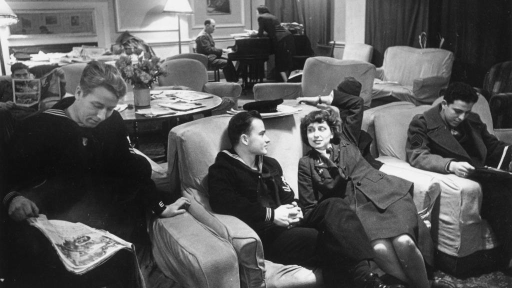 27th January 1945: Members of the forces talking and listening to classical records as they relax in Rainbow Corner the American Service Men's club in Piccadilly, London which is open to all members of the Allied forces. Original Publication: Picture Post - 1887 - Inside Rainbow Corner - pub. 1945 (Photo by Kurt Hutton/Picture Post/Hulton Archive/Getty Images)