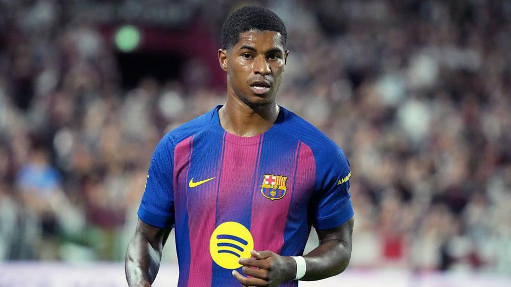 Marcus Rashford looks on in a Barcelona kit
