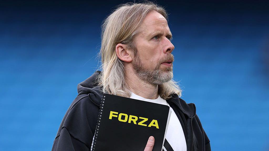 Austin MacPhee, set-piece coach of Aston Villa, looks on from the touchline
