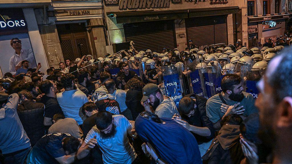 Protesters clash with Turkish anti riot police officers as they gather to protests Leman cartoon magazine in Istanbul