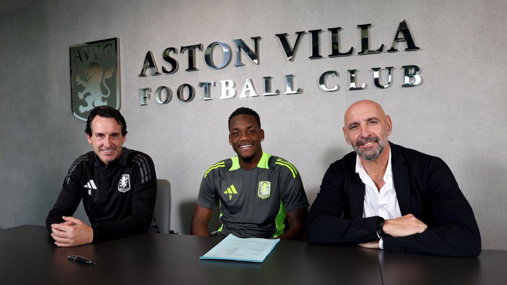 Jhon Duran of Aston Villa signs a new contract pictured with Unai Emery and Monchi