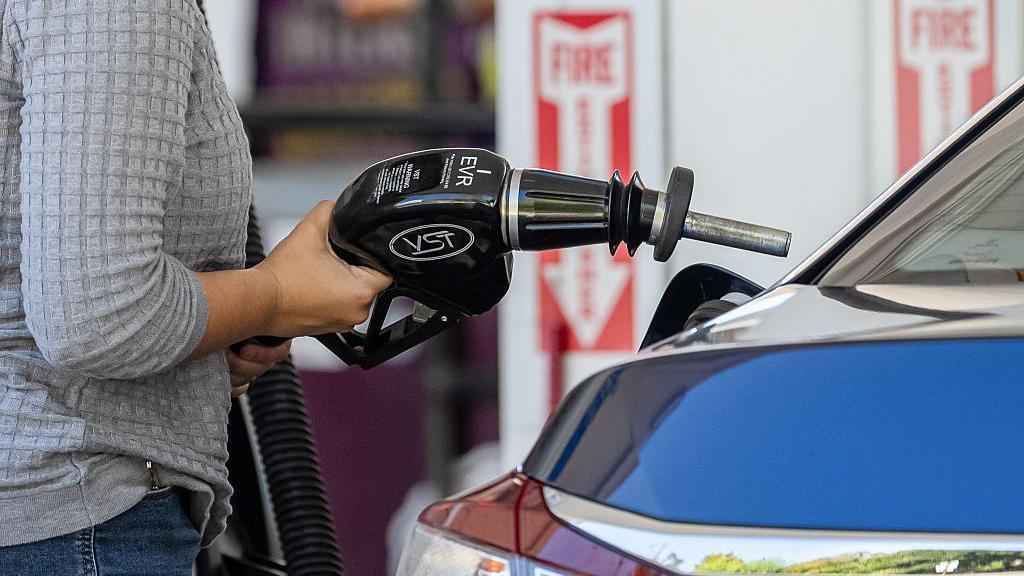 A driver refuels a vehicle at a Shell petrol station in Palo Alto, California, US