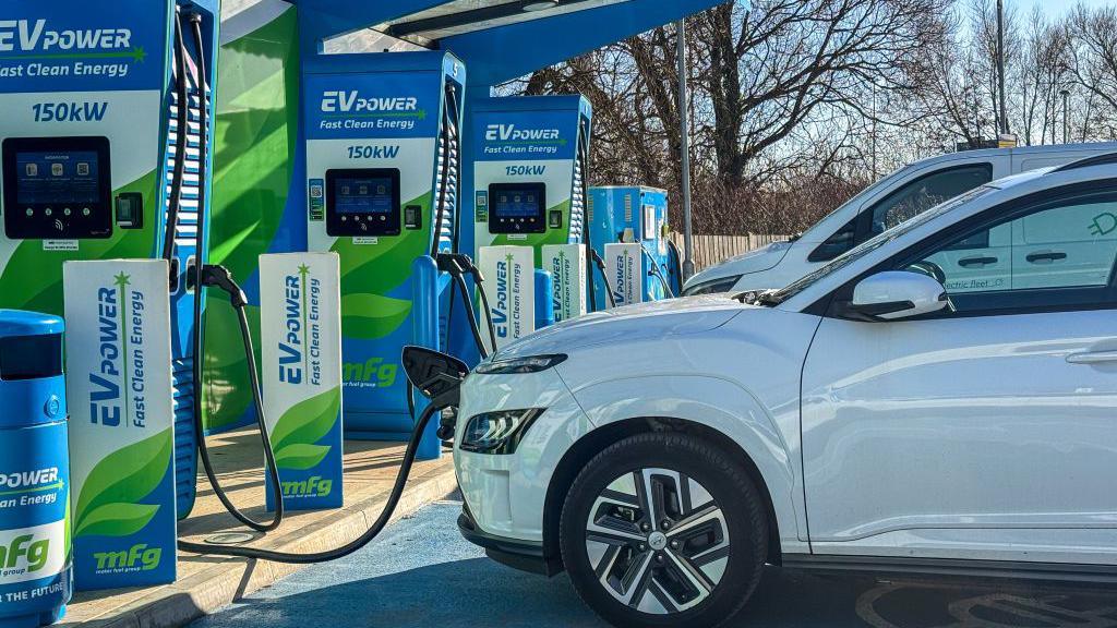 Cars recharge at a charging station for electric vehicles at a service station, on 30 January 2025 in Cornwall, UK