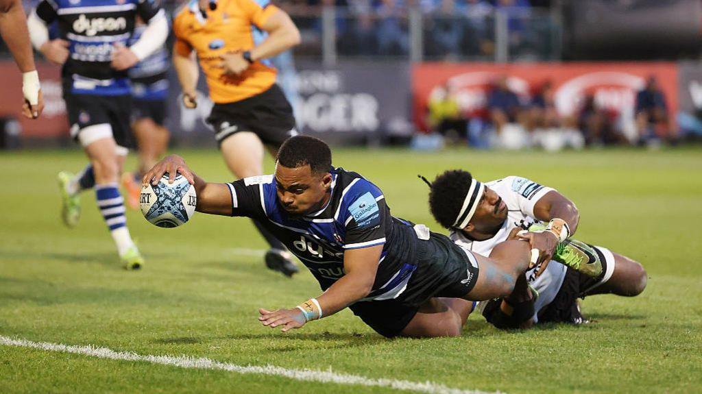 Max Ojomoh stretches over to score under a tackle from Kalaveti Ravouvou