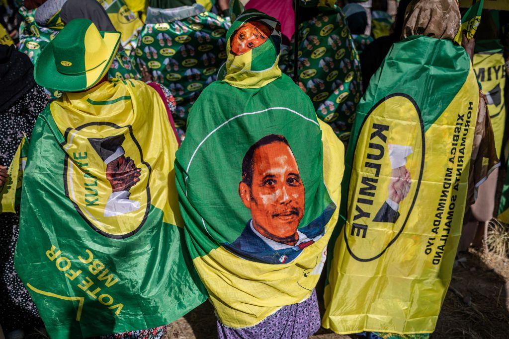 Supporters of the ruling party wear flags displaying the party colours and a portrait of the presidential candidate Muse Bihi Abdi during a final campaign rally in Hargeisa.