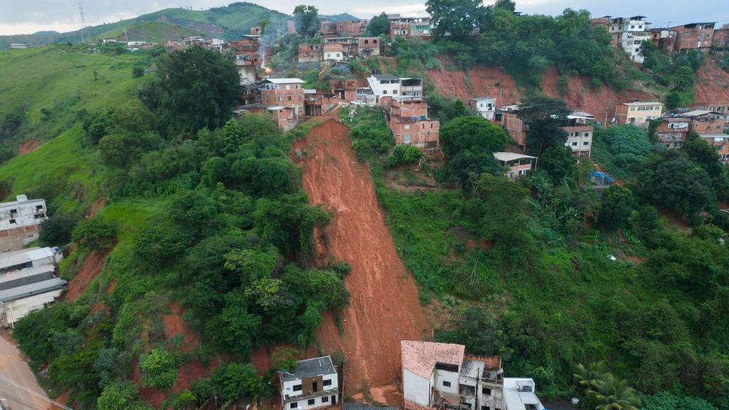 Aerial view of a landslide in Ipatinga, where red mud swept away houses on a hillside. 