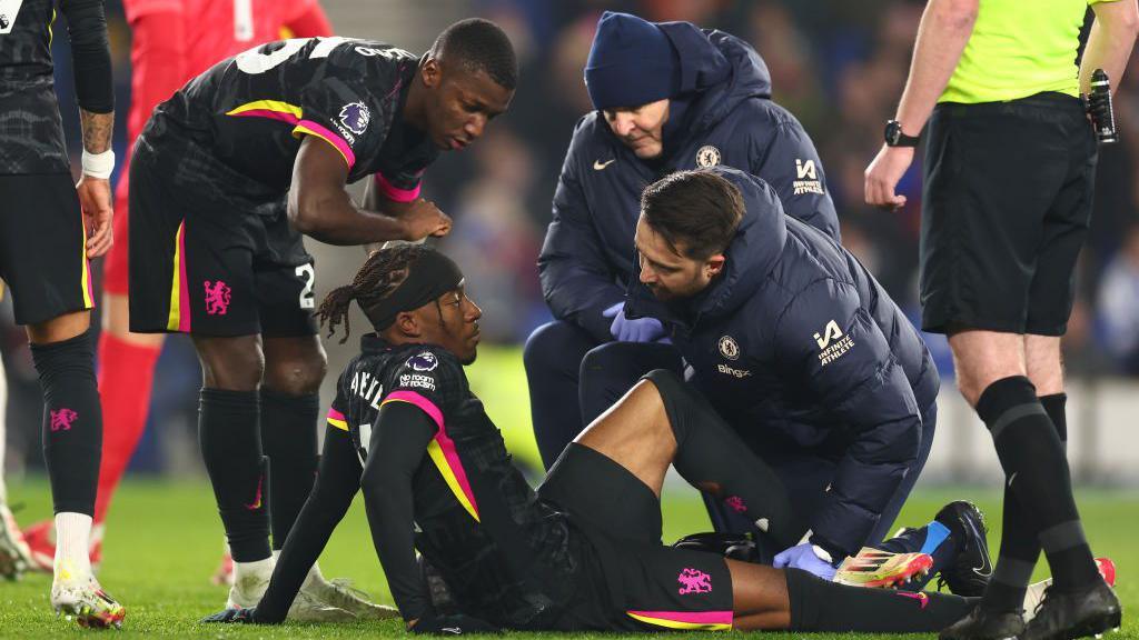 Noni Madueke receives treatment on the pitch 