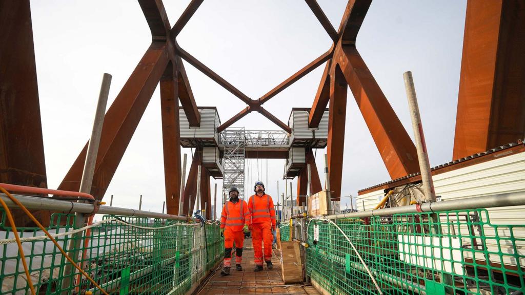 Engineers on a bridge