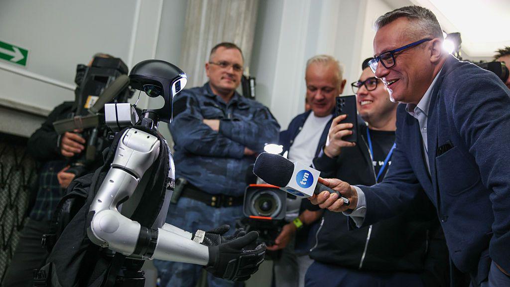 robot Edward being interviewed by reporters in Poland.