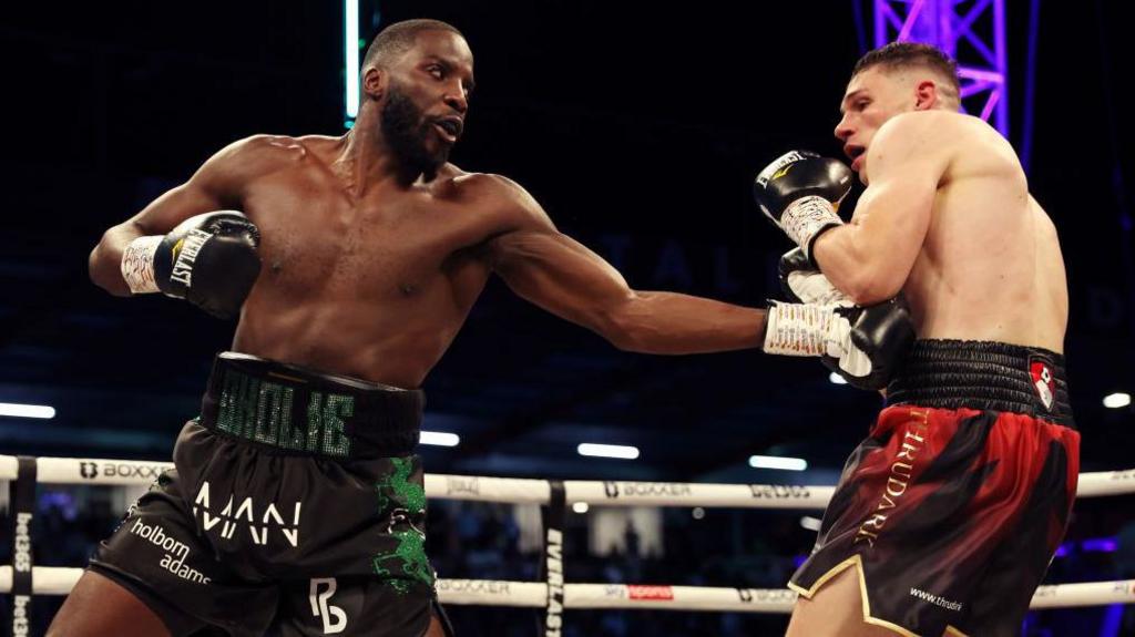 Lawrence Okolie aims a punch at Chris Billam-Smith's body