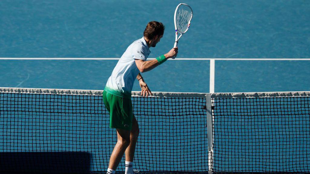 Daniil Medvedev smashes a camera on the net during his match