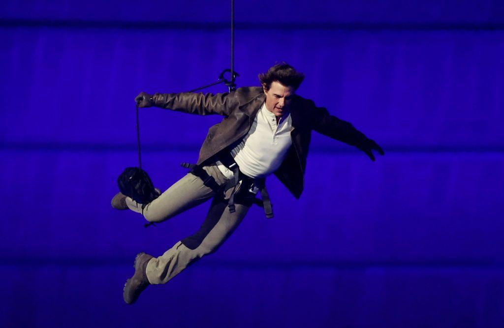 Actor Tom Cruise jumps from the roof of the Stade de France during the Closing Ceremony of the Olympic Games Paris 2024.