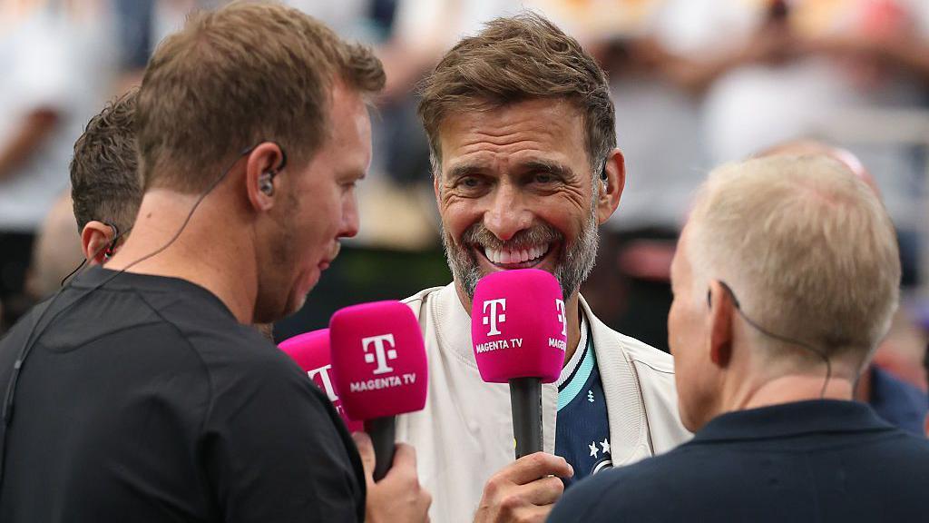 Jurgen Klopp speaks with Germany coach Julian Nagelsmann during television coverage of Germany's World Cup game with Curacao in 2026