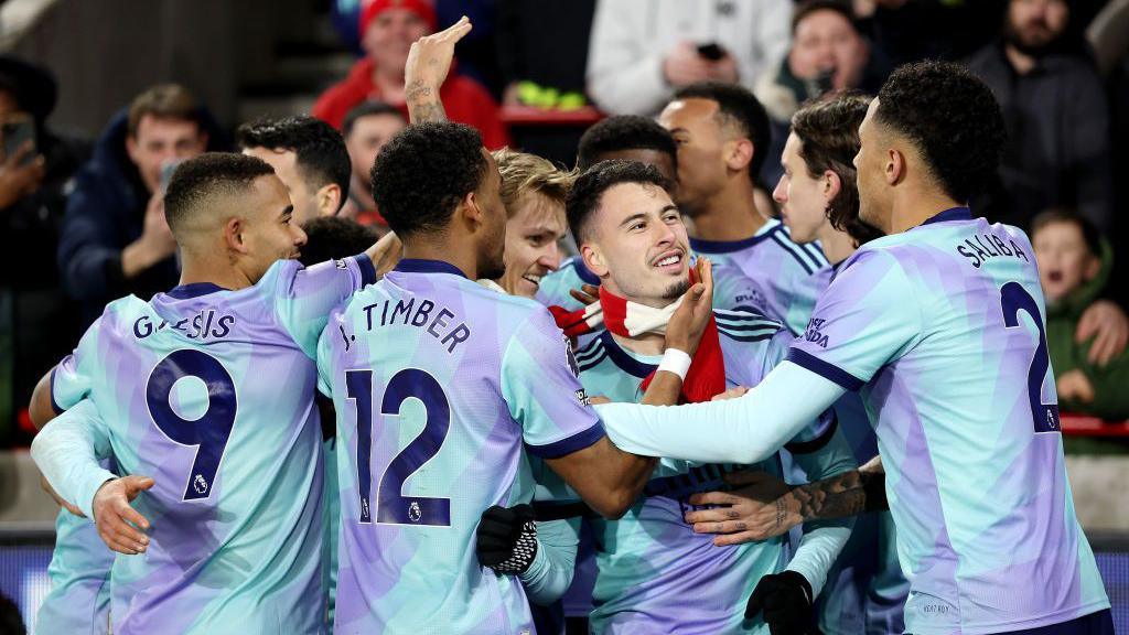 Arsenal celebrate scoring their third goal against Brentford