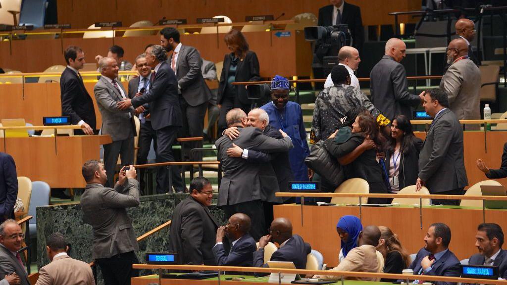 Palestinian diplomats celebrate after the UN General Assembly endorses a resolution demanding Israel end "its unlawful presence in the Occupied Palestinian Territory" within 12 months, at UN headquarters in New York (18 September 2024)