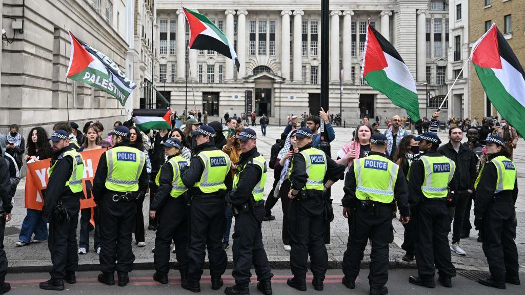 London police prevent Youth Demand protesters stepping into the road after they gathered at the Jubilee Gardens