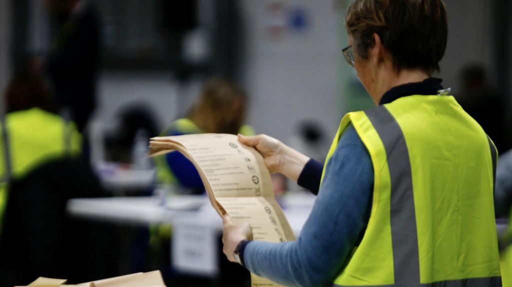 person holding ballot paper